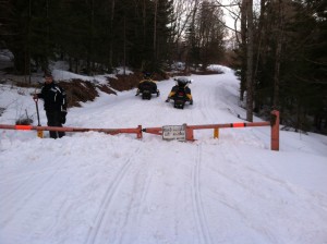 Scott Ballard { with the shovel } and Mike Stewart locking the gates on April 15, 2013. There is still good snow here at the gate on the CCC Road!